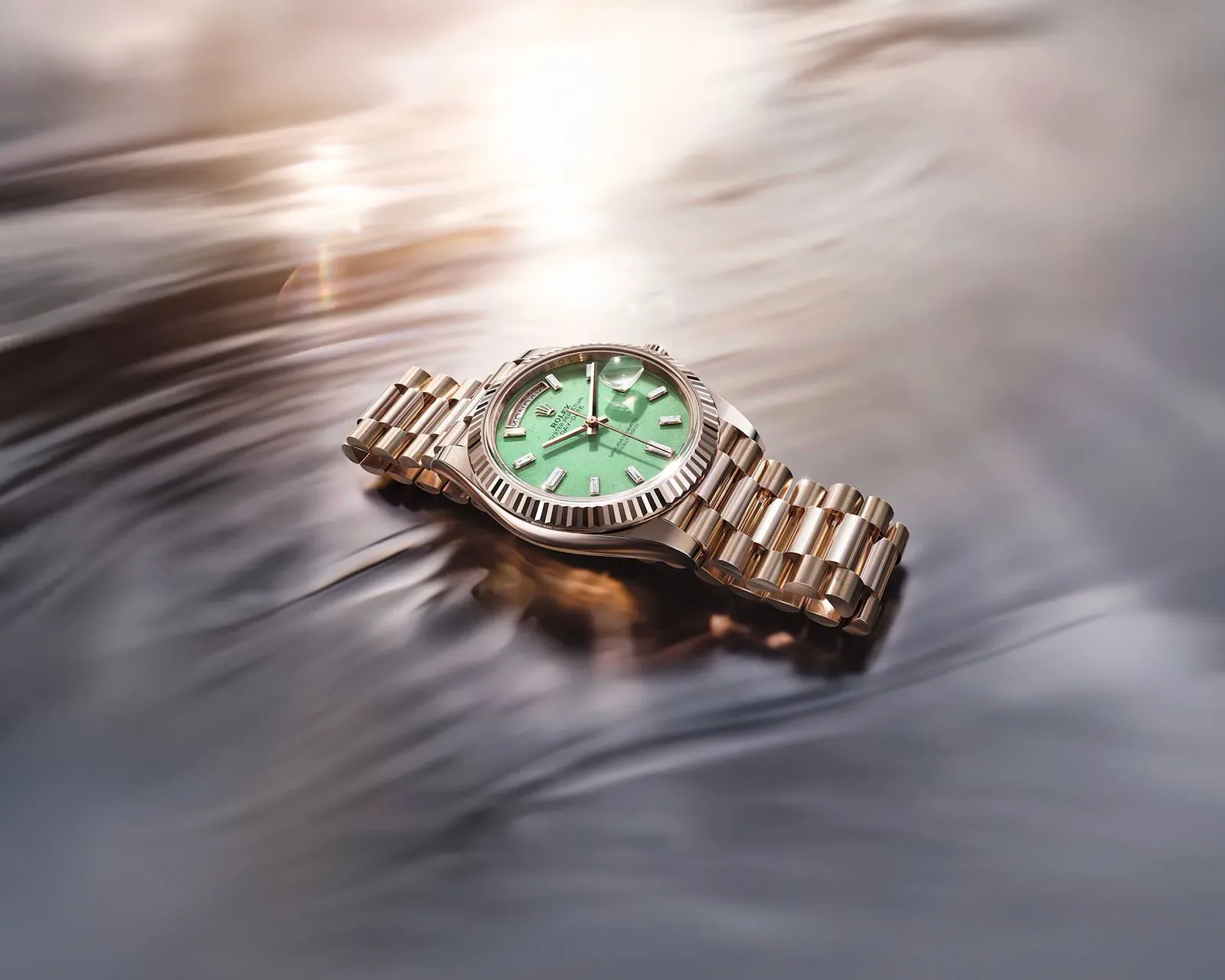 ساعة Rolex Oyster Perpetual Day-Date 40 بتصميم أنيق، مصنوعة من Jubilee Gold، مع مينا أخضر لامع، تعكس الفخامة والابتكار في صناعة الساعات.