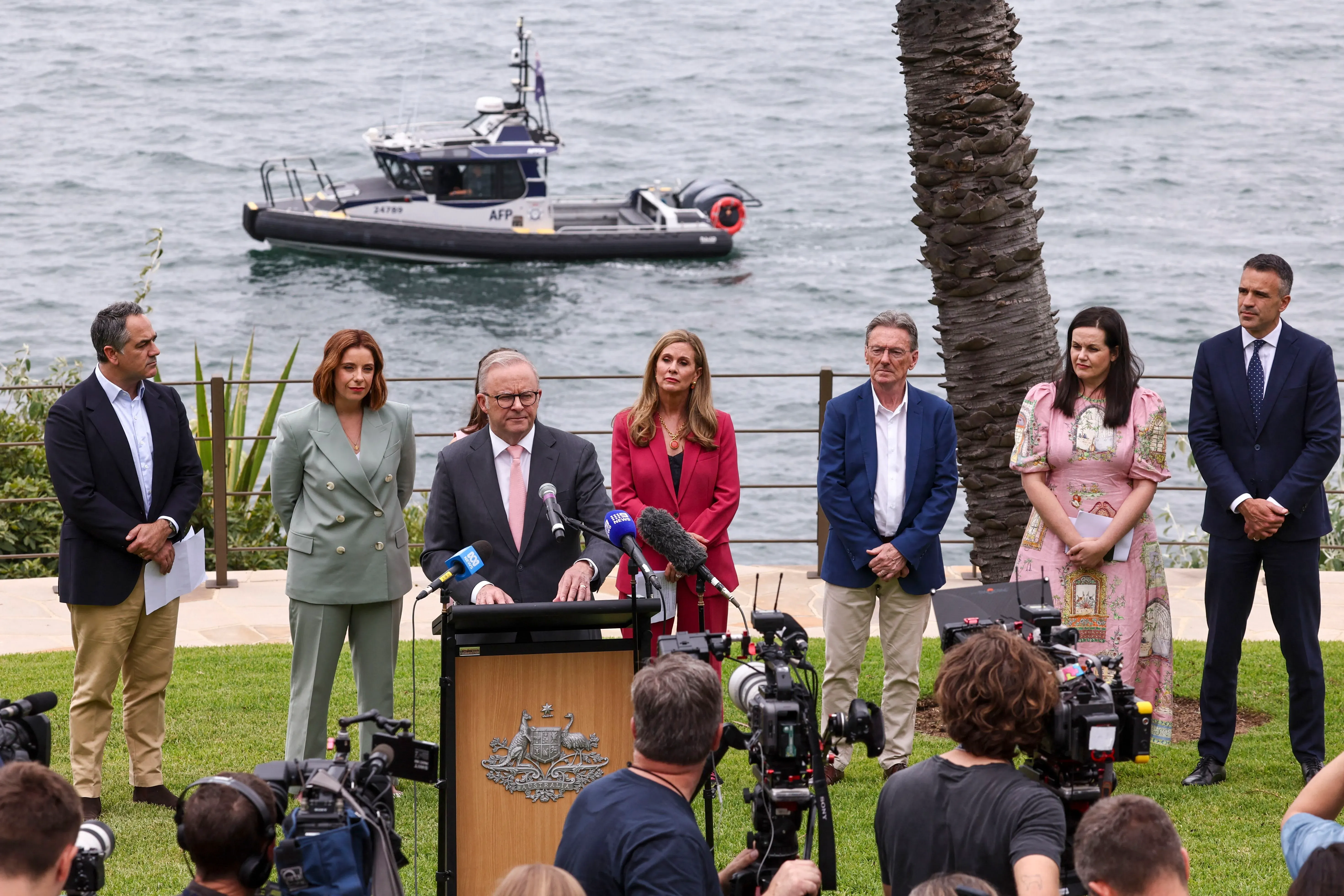 رئيس الوزراء الأسترالي أنتوني ألبانيز يتحدث في مؤتمر صحفي حول حظر وسائل التواصل الاجتماعي للأطفال، مع وجود مسؤولين آخرين خلفه.