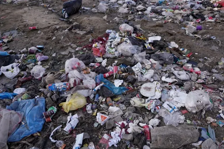 تظهر الصورة كومة من النفايات المبعثرة على الأرض، مما يعكس الظروف المعيشية الصعبة في غزة وازدياد مشكلة الجرذان التي تهدد السكان.