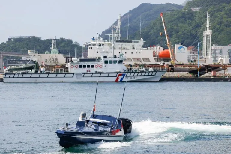 زورق بحري سريع يتجه نحو ميناء سواو في تايوان، مع ظهور سفن أخرى في الخلفية، في سياق تطوير قوة بحرية بدون طيار.