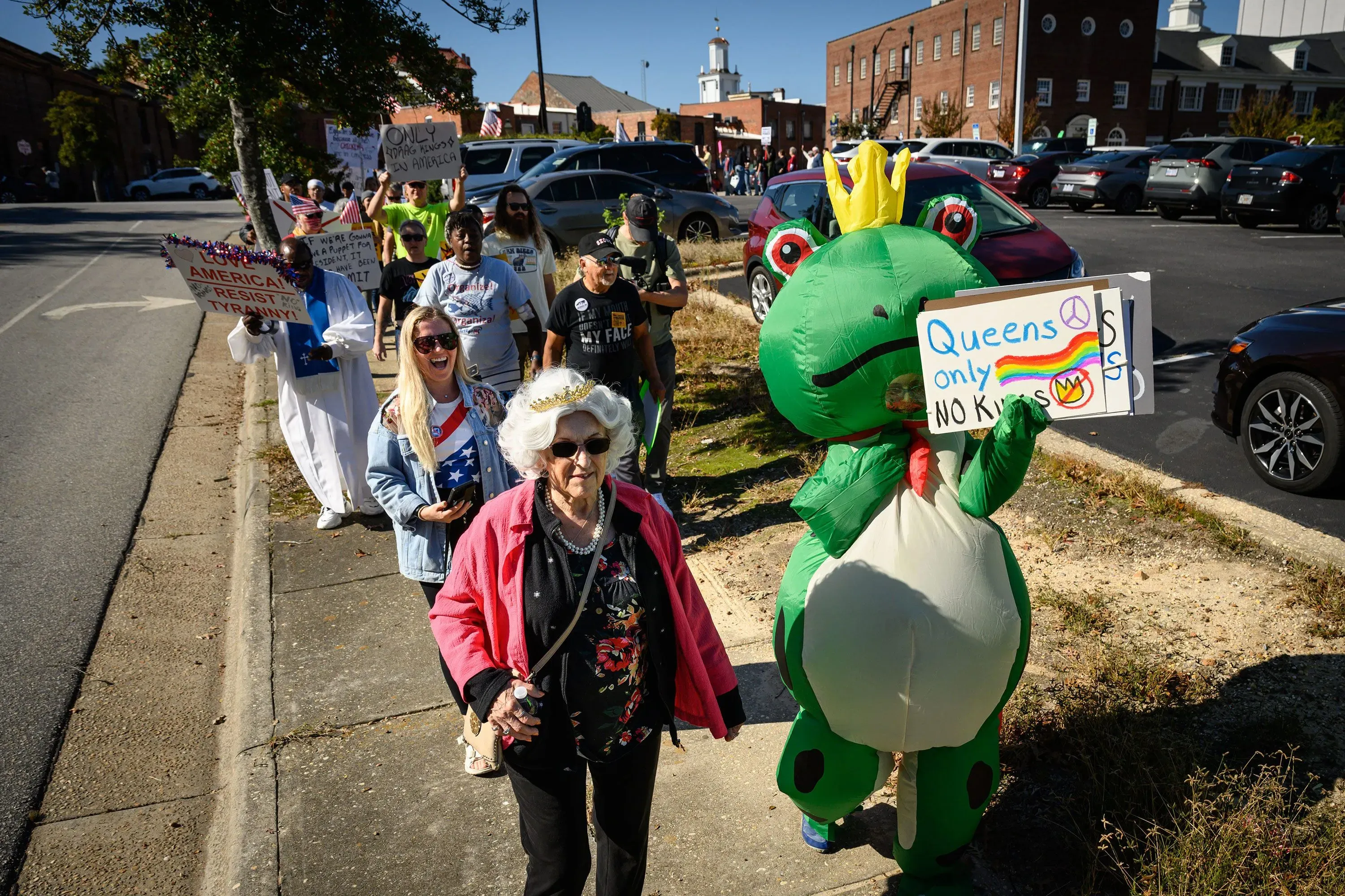 مظاهرة في واشنطن العاصمة تضم مجموعة متنوعة من المتظاهرين، بينهم امرأة مسنّة ترتدي ملابس زاهية وشخص يرتدي زي ضفدع.