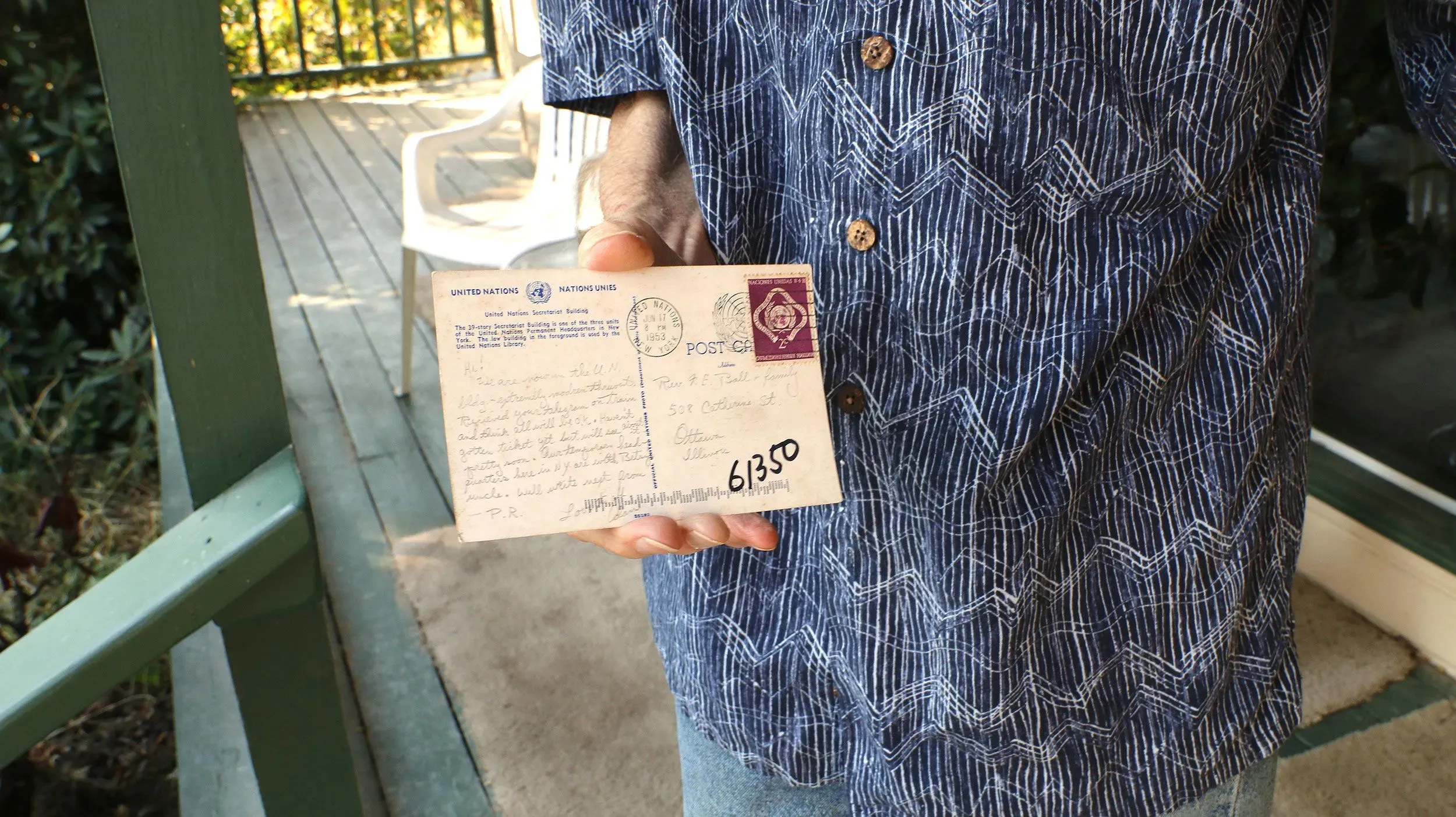 بطاقة بريدية قديمة من الأمم المتحدة يحملها رجل، تم إرسالها في 1953، تم العثور عليها بعد 72 عامًا، تعود إلى القس ف. إ. بول.