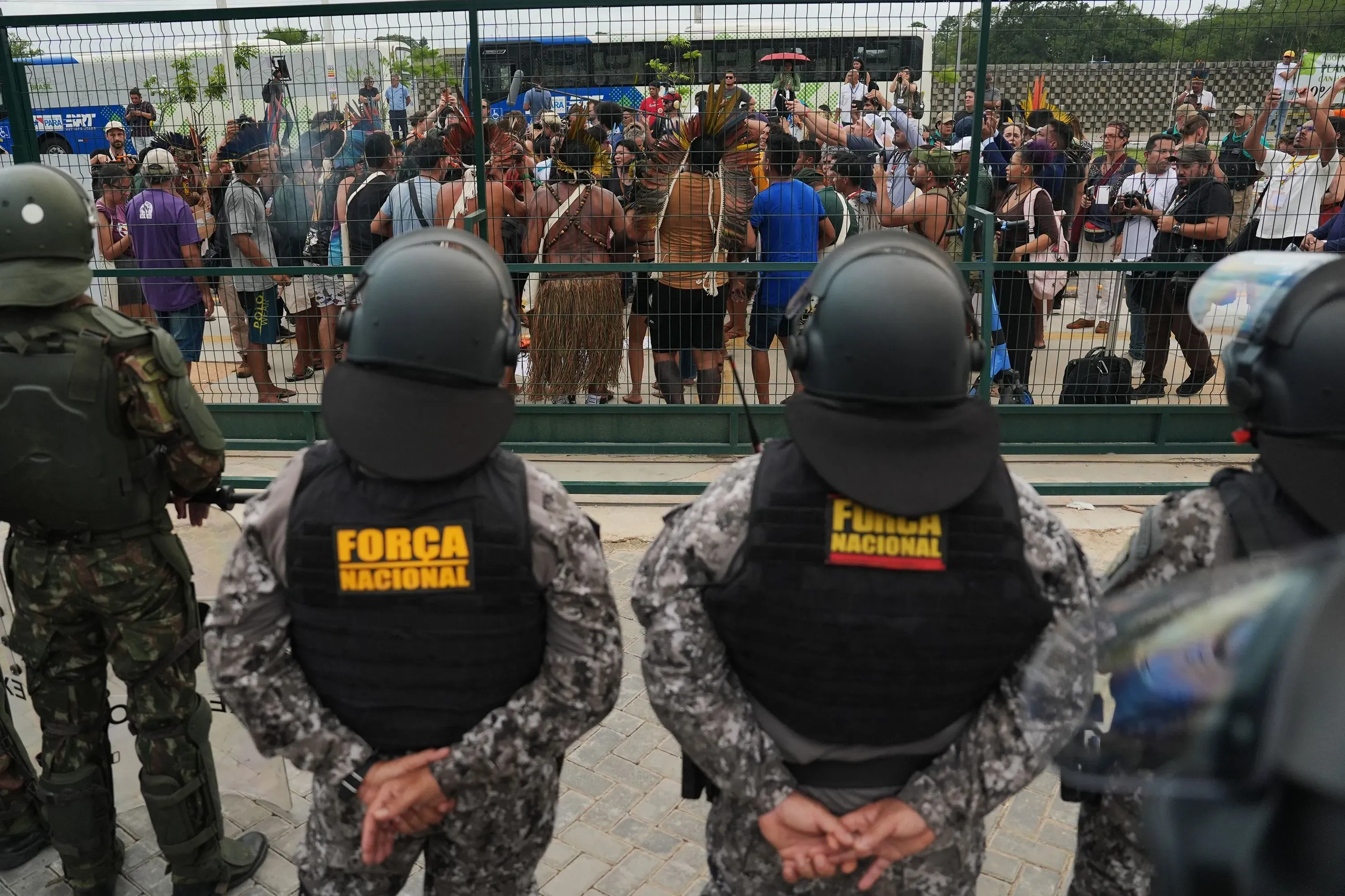 مظاهرة سلمية للسكان الأصليين أمام مؤتمر الأمم المتحدة للمناخ، مع وجود قوات الأمن في الخلف، تعبيراً عن مطالبهم لحماية غابات الأمازون.