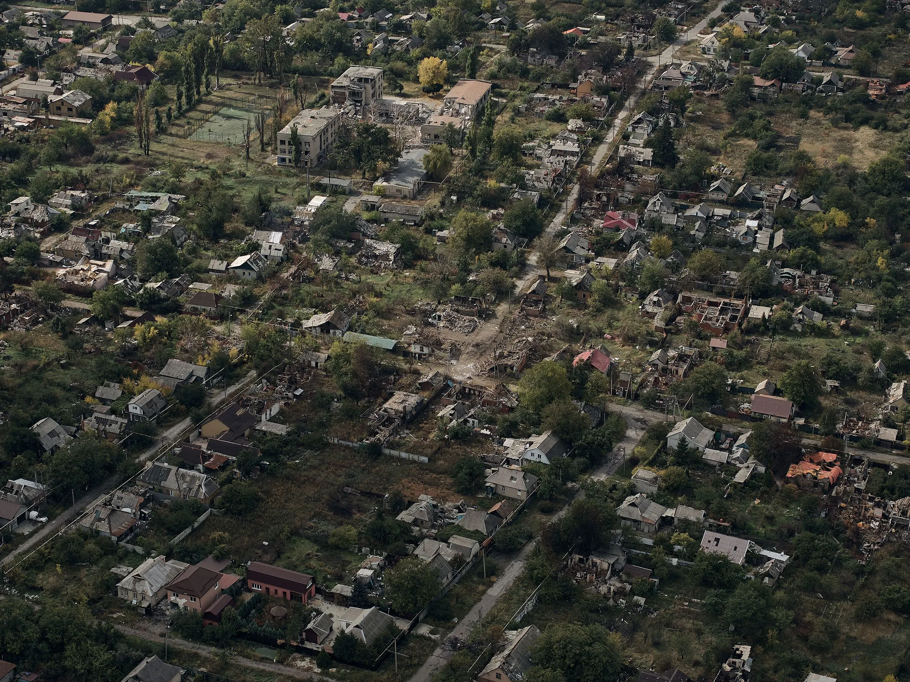 صورة جوية لمدينة بوكروفسك الأوكرانية المدمرة، تظهر المنازل المهدمة والطرق المهجورة، تعكس تأثير الحرب المستمر.
