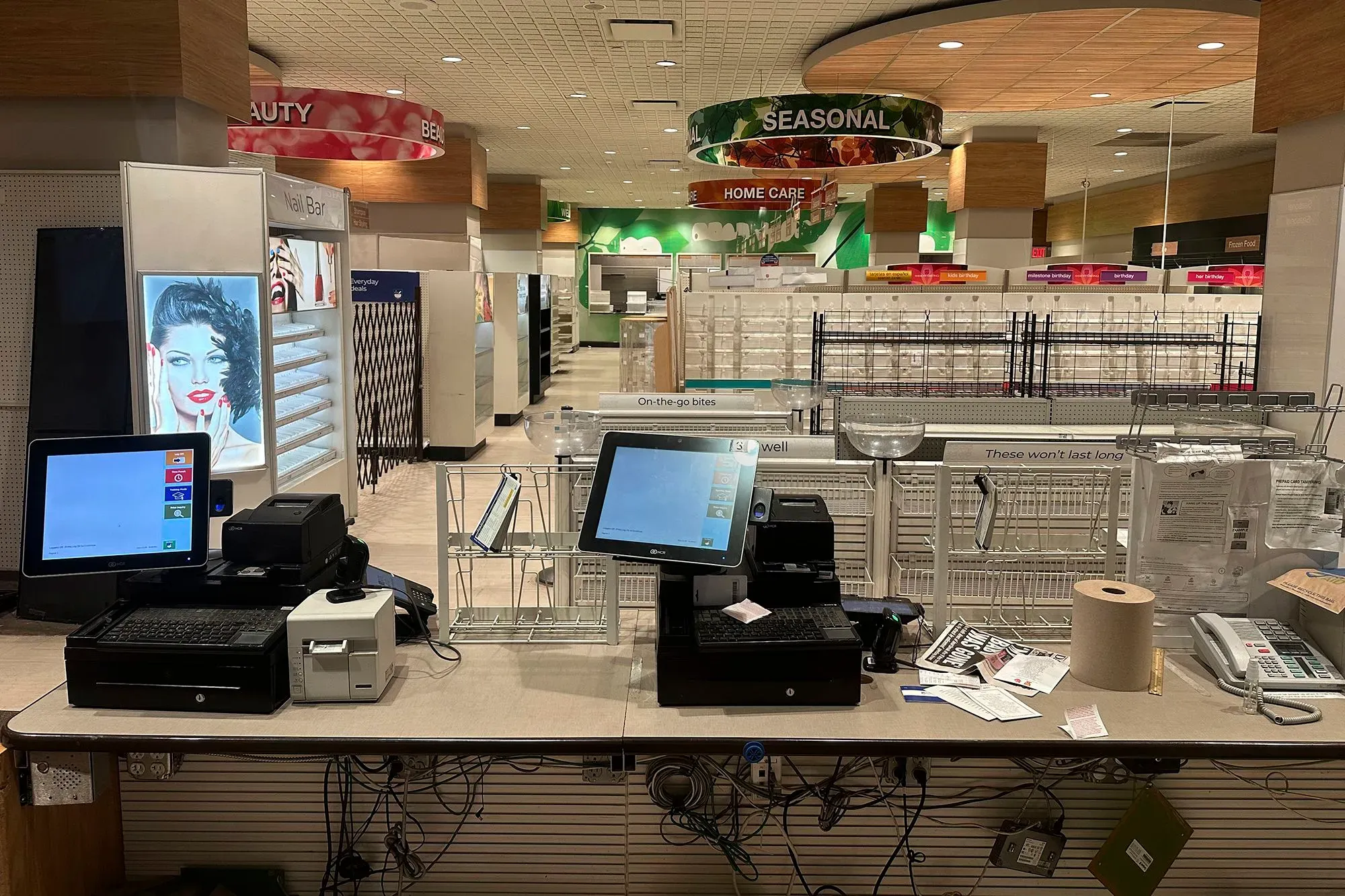 متجر مغلق مع صناديق كاشير فارغة وأرفف خالية، يعكس تأثير الإفلاس على سلاسل التجزئة مثل رايت إيد وفوريفر 21.