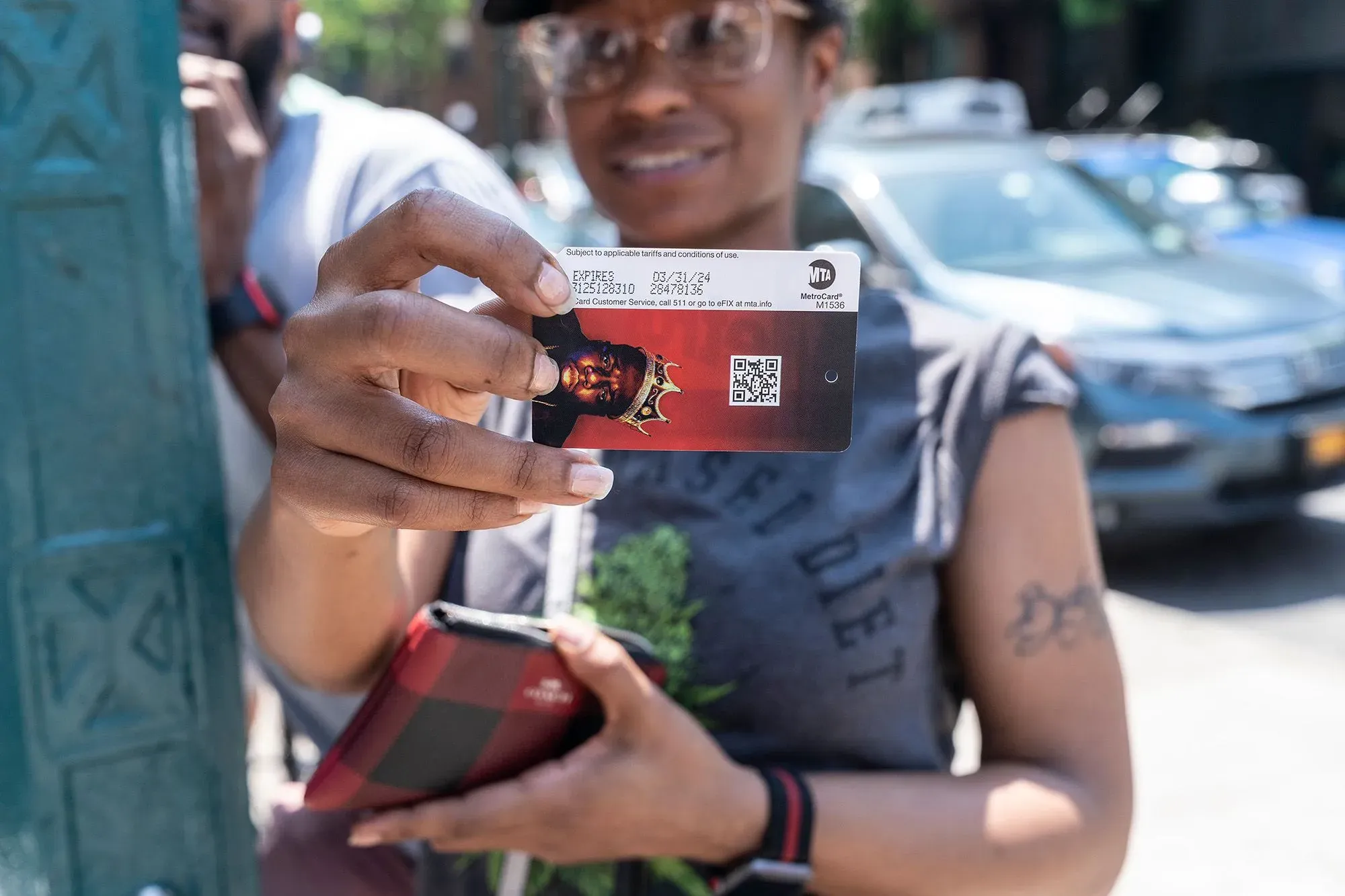 شخص يحمل بطاقة مترو أنفاق نيويورك، مع تفاصيل واضحة للبطاقة، في مشهد حضري يعكس التغيير نحو نظام الدفع بدون تلامس.