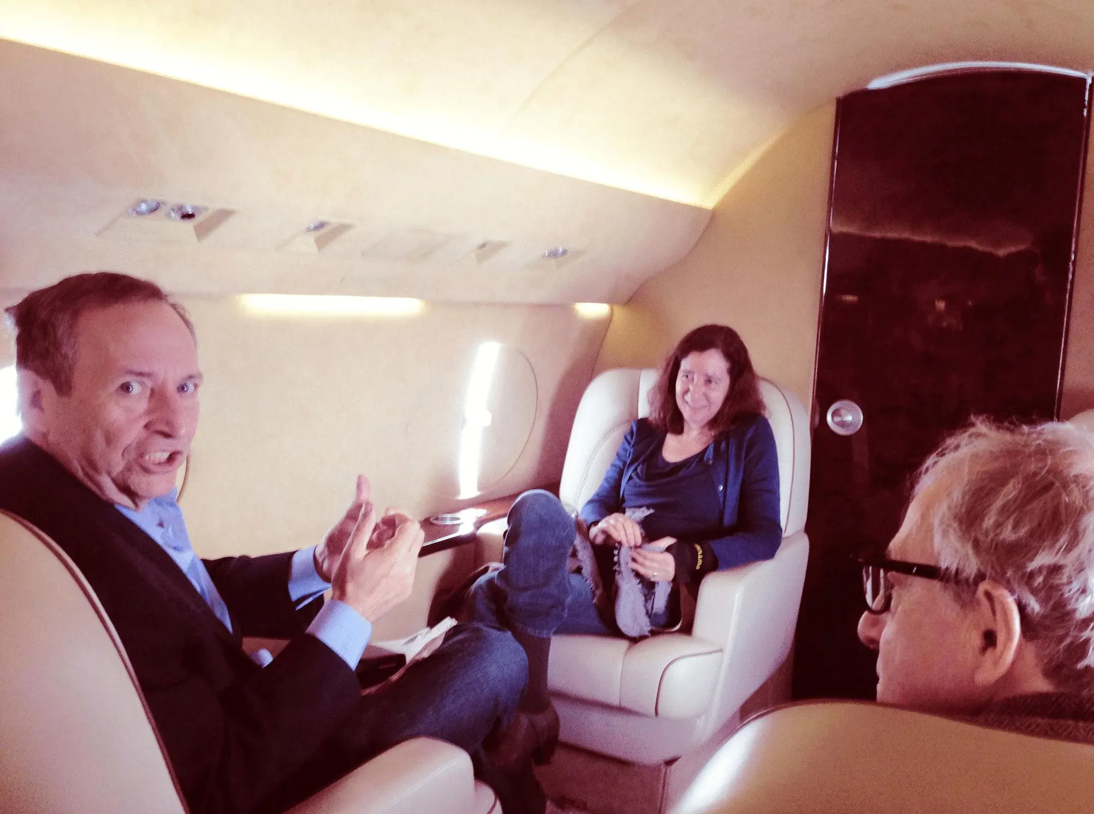 صورة تظهر مجموعة من الأشخاص داخل طائرة خاصة، حيث يجلس رجل يتحدث مع الآخرين. تعكس الأجواء تفاعلات اجتماعية في سياق مرتبط بقضية جيفري إبشتاين.