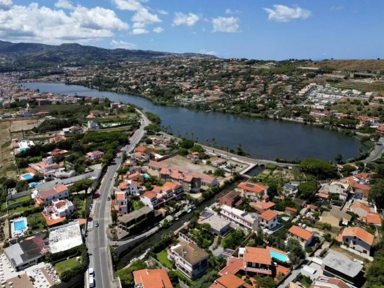 منظر جوي لمدينة ميسينا في صقلية، يظهر المنازل والمسطحات المائية المحيطة، في سياق الاحتجاجات ضد مشروع جسر مضيق ميسينا.