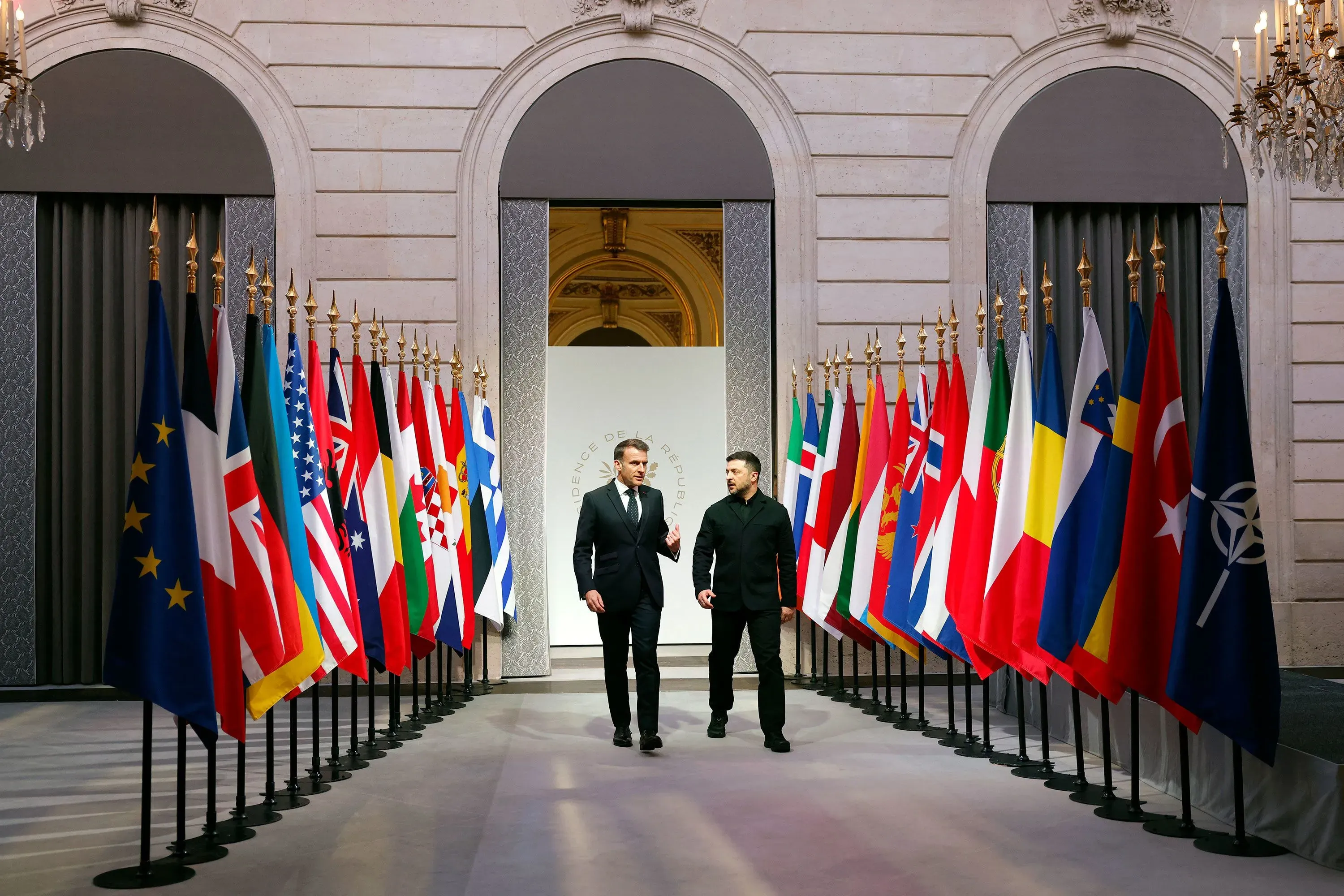 اجتماع بين رئيس الوزراء البريطاني كير ستارمر والرئيس الفرنسي ماكرون في باريس، مع أعلام الدول المشاركة في التحالف لدعم أوكرانيا.