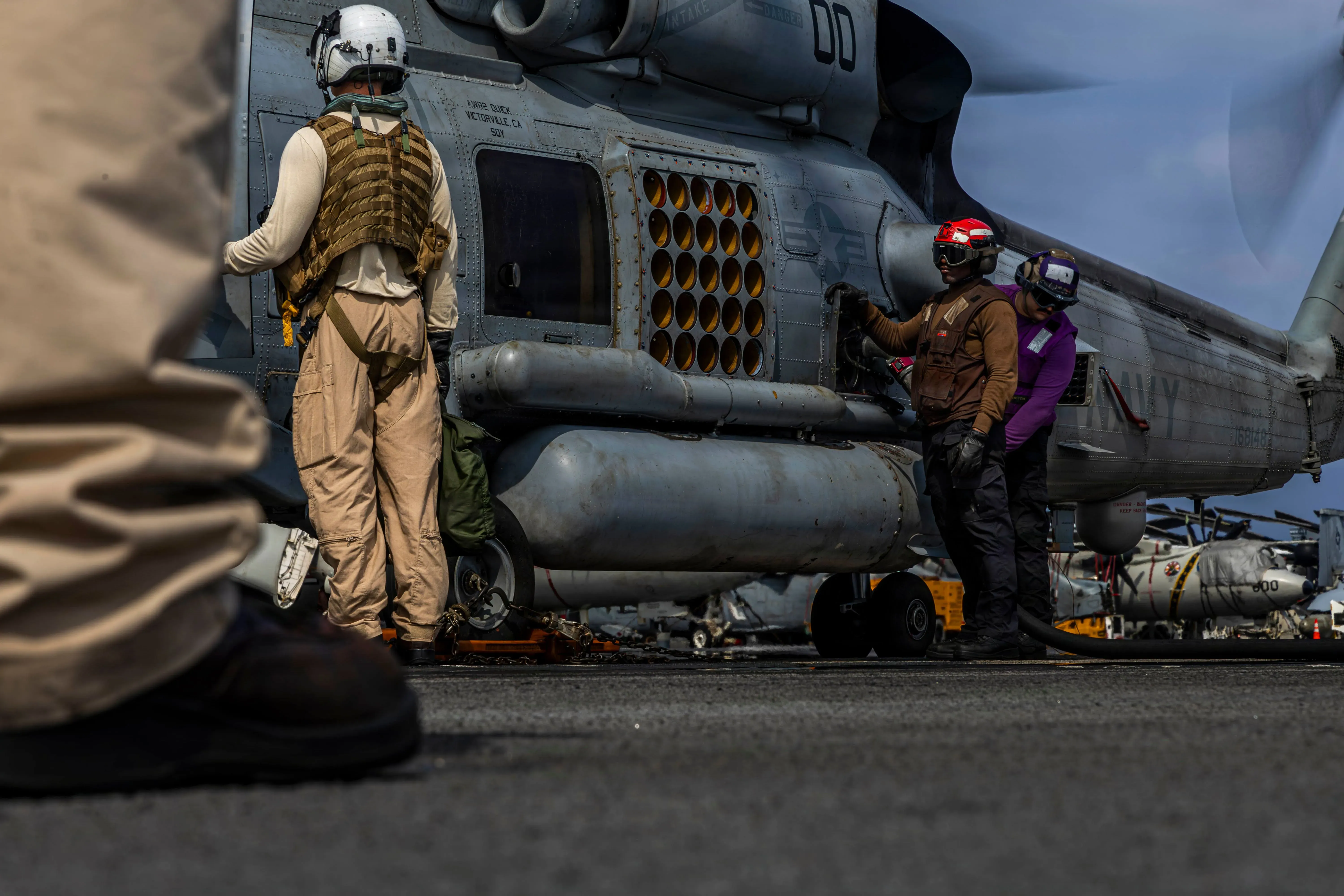 أفراد من القوات الأمريكية يقومون بإعداد طائرة هليكوبتر عسكرية على متن حاملة الطائرات "يو إس إس أبراهام لينكولن" خلال مناورات جوية في الشرق الأوسط.