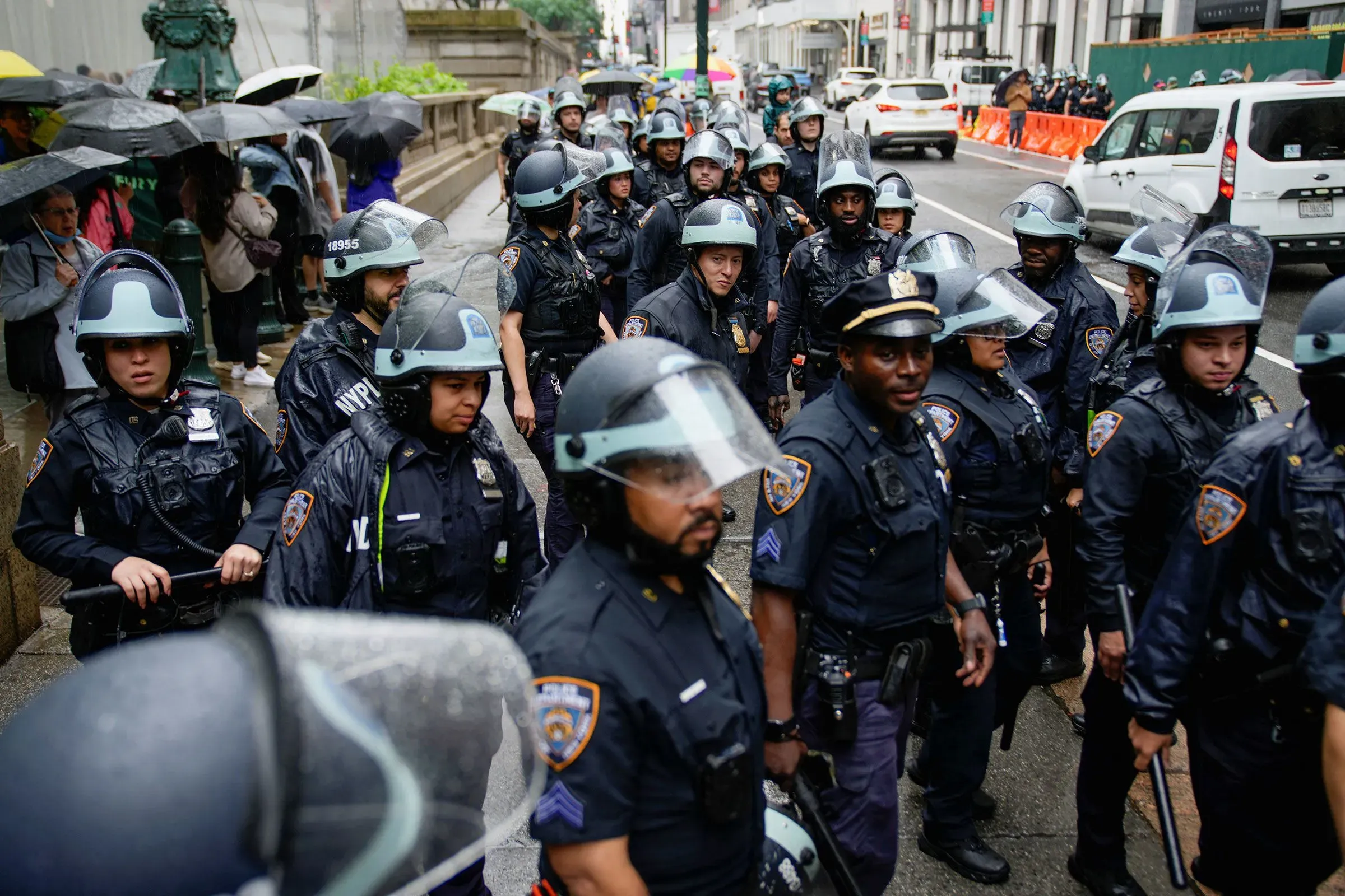 تجمع عدد من ضباط شرطة نيويورك في ملابسهم الرسمية، وسط أجواء ممطرة، خلال مظاهرة أو حدث عام في المدينة.