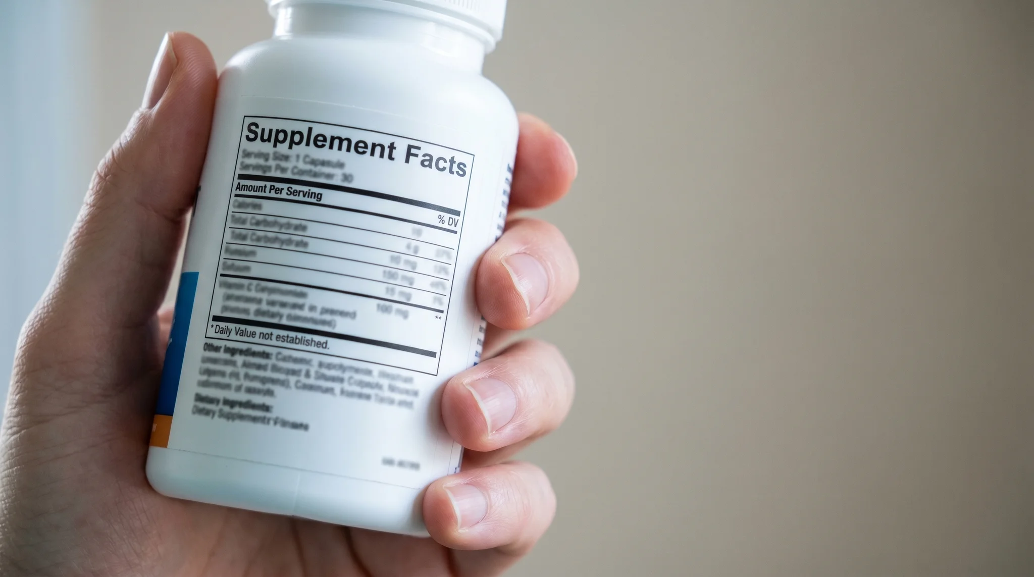Close-up of a supplement bottle turned to show the Supplement Facts panel and ingredient list