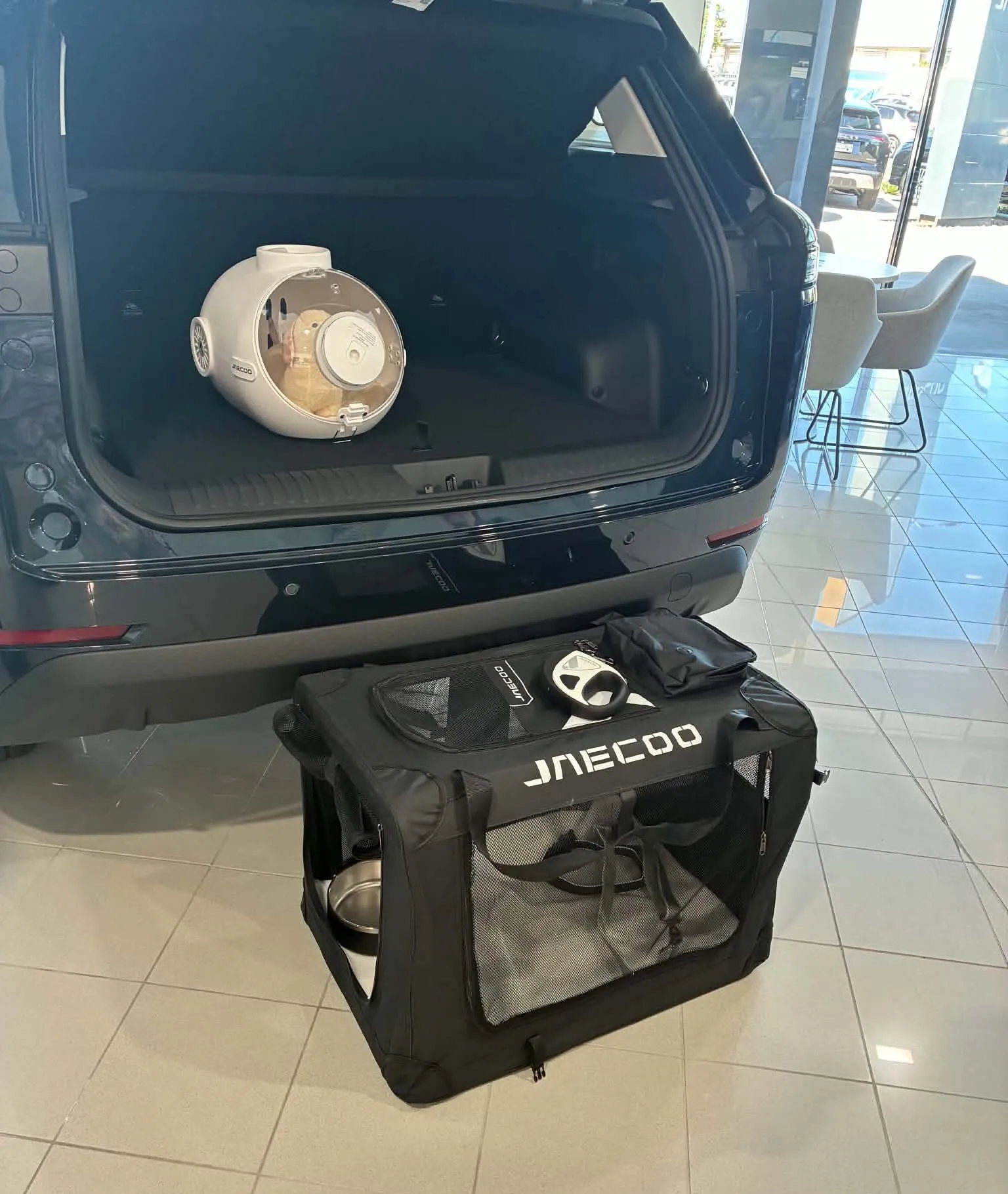 حقيبة نقل حيوانات تحمل شعار Jaecoo أمام صندوق سيارة كهربائية Jaecoo J5 في معرض سيارات بأستراليا.